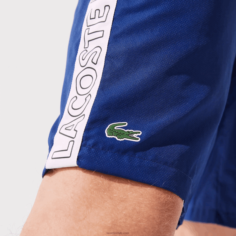 hombres Lacoste azul blanco emj shorts deportivos con franjas laterales N6XZ21505